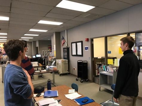 Some students standing for the pledge in the library.