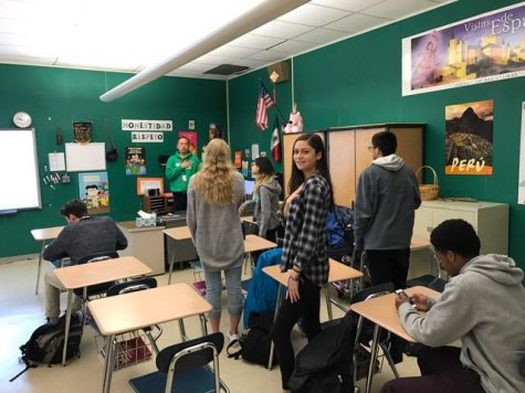 A room of students during the pledge of allegiance. 