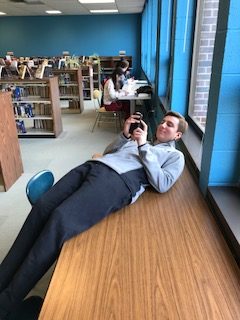 Student Association President, Chase Jeter, seen just chillin on a table in the library. 