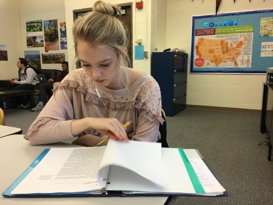 Megan Swindle, a student at Hall high, listens to By Your Side as she works.