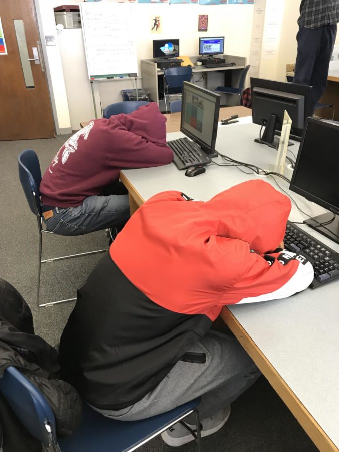  These students are falling asleep in class because they woke up so early. 
