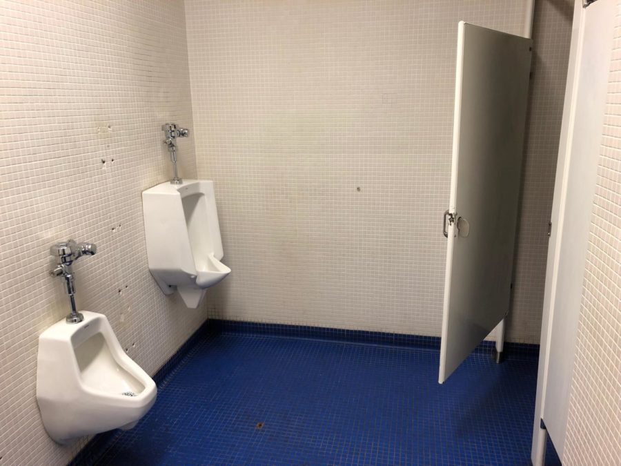 The urinal on the left has zero privacy and cannot be used. 
