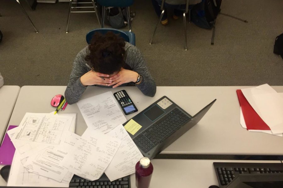 A student pictured working on school work and studying for the SAT that took place this week.