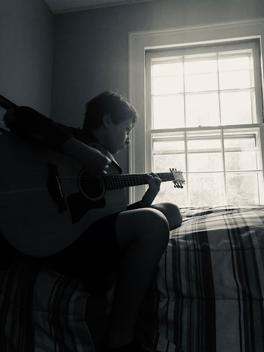 Elliot Kershen is seen in his bedroom doing what he loves. Playing guitar.