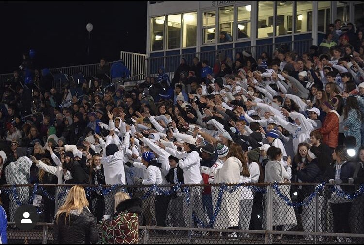 Halls fan section cheering on Halls football team. 