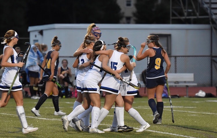 Field Hockey playing together.