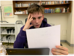 Jack C, a junior at Hall High School, reviews a financial aid plan 
