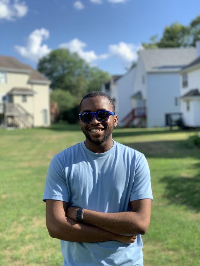 This picture is me in my backyard smiling for the camera on an average summer day.