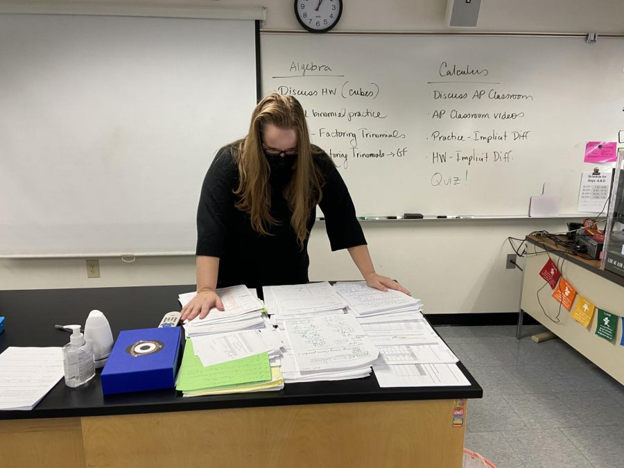 A high school math teacher looks at all the papers she has to grade as she stresses over the new schedule. 