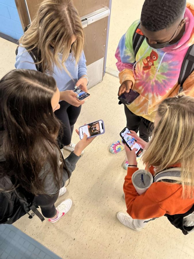 Here we can see four students caught using social media in the middle of the hallway, showing just how attached our generation is to phones and social media. 