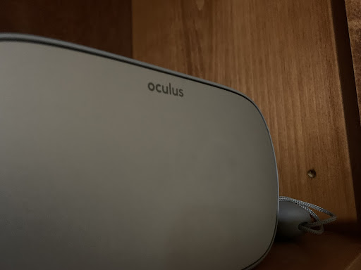 An Oculus Go headset sits on the top of a shelve, collecting dust.