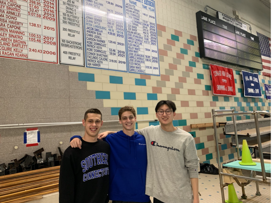 Swimmers: Andrew Sun, Carson Raisner, and Kobe Dominguez, pose in front of their new record in the 200 freestyle relay. 
