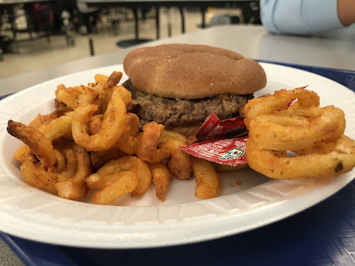 School cafeteria’s burger and curly fries (left), and sun butter sandwich (right)