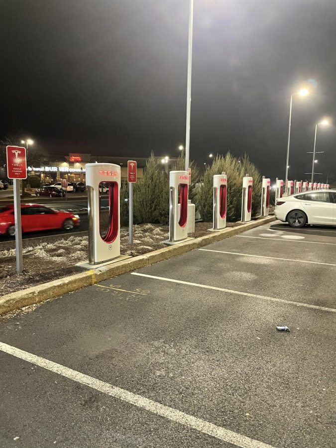 A civilian charging their vehicle at a Tesla charging station within Buckland Hills Plaza in Manchester, Connecticut on March 17th, 2022. 
