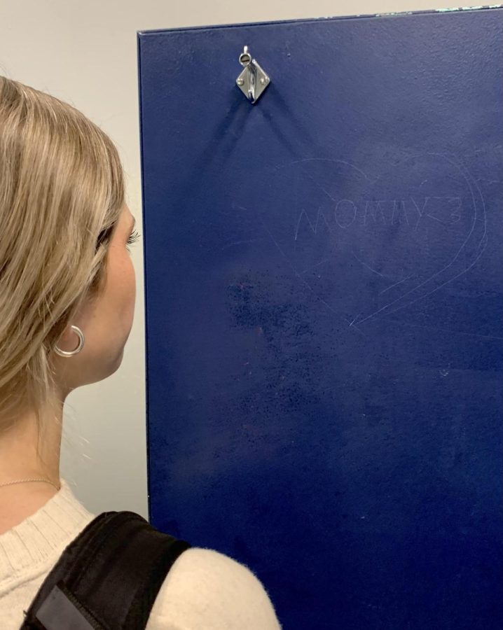 Students witness vandalism in the bathroom on a daily basis. The bathroom walls are covered with inappropriate sayings. Here, we have a student looking at the word “mommy” on a bathroom door. 