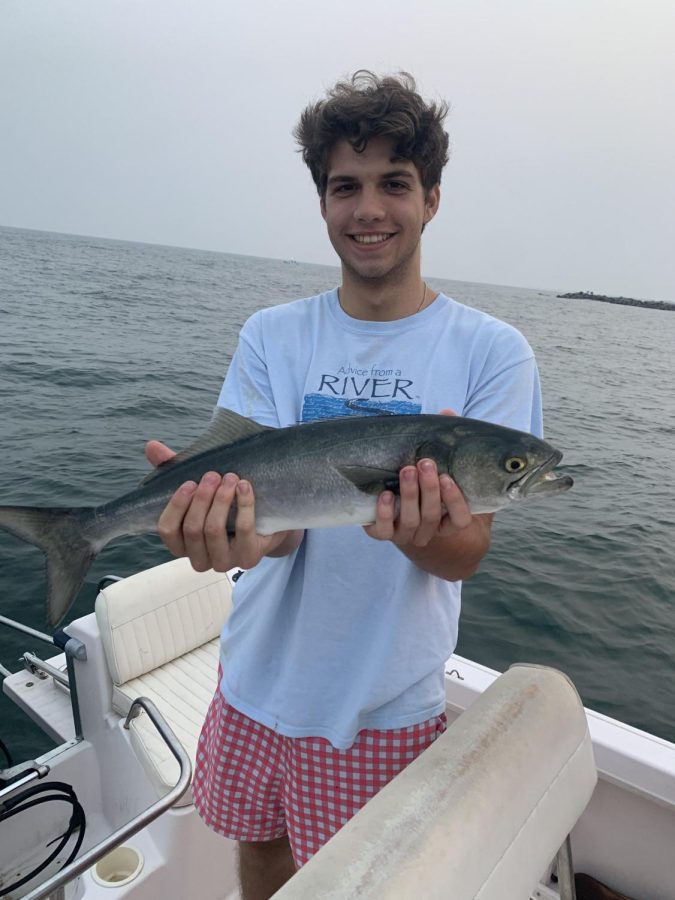Kanaga, holding an 18 inch Bluefish on a fishing excursion in August 2021.