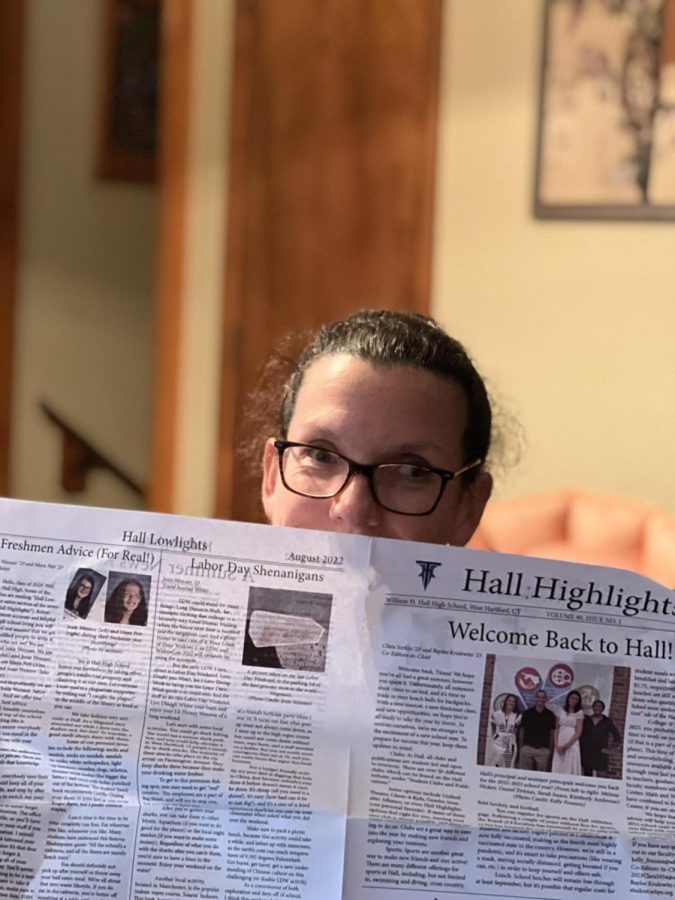 Kelly Fransen reads the proudly reads the paper her club put together!