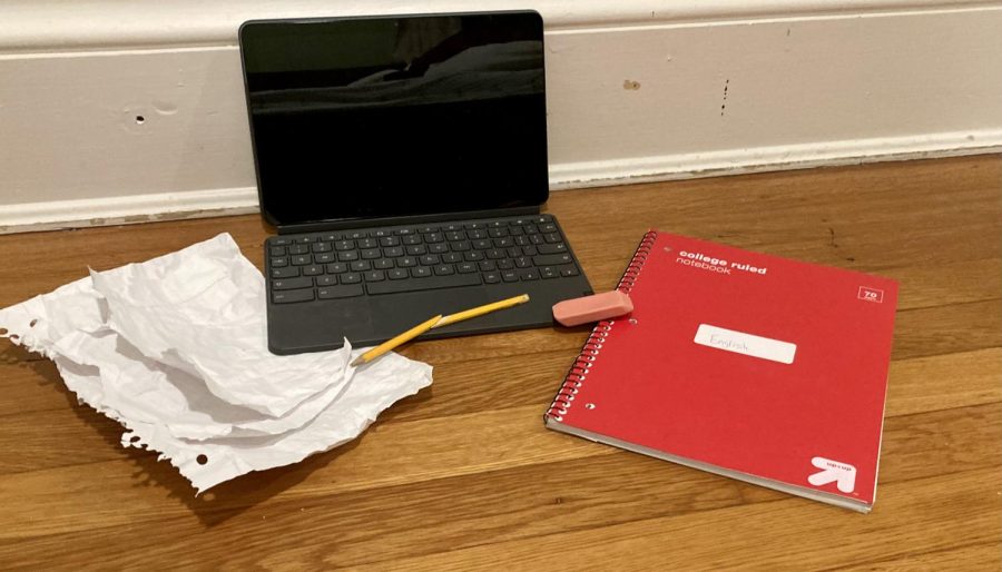 A standard laptop surrounded by crumbled paper, broken pencil, eraser, and notebook. Taken on Thursday, October 20th, showing how people are moving away from the standard way of taking notes.