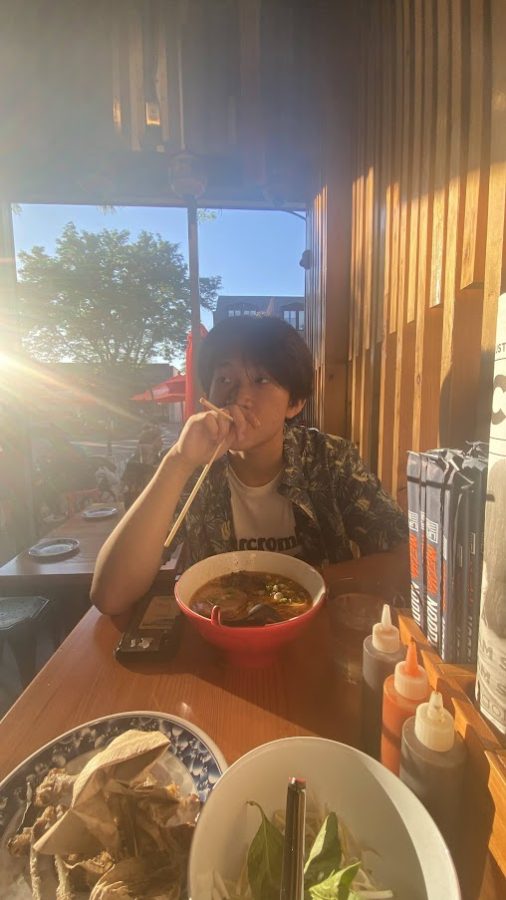 Caleb enjoying a bowl of hearty ramen. 