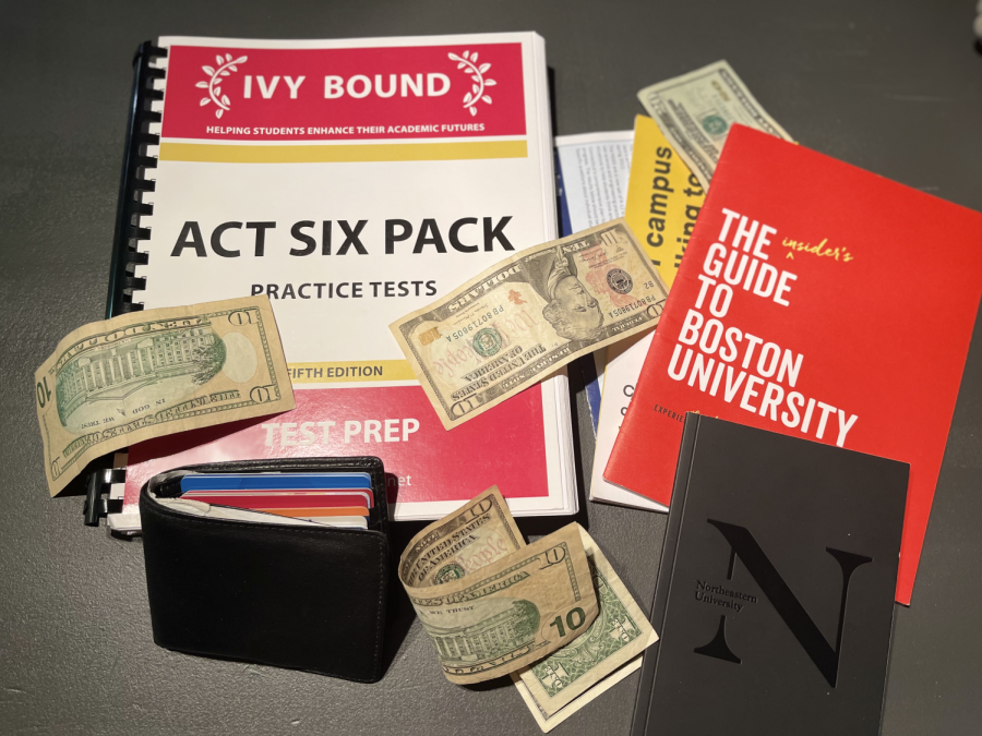 Many college items and expenses scattered on a table.