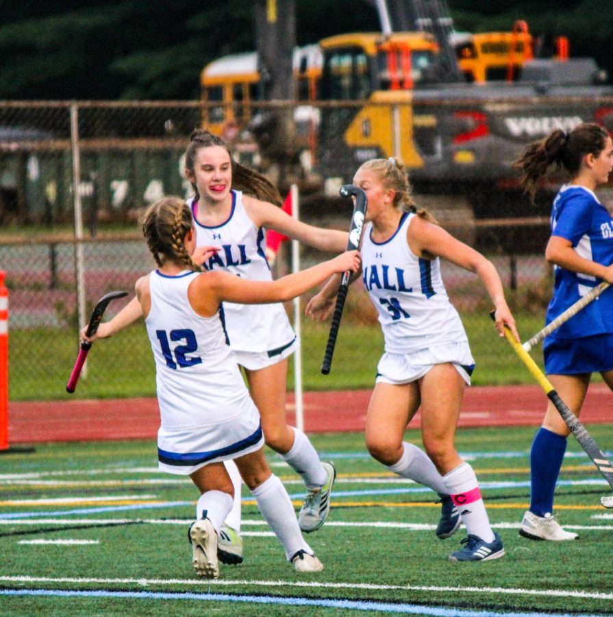 Players on the girls varsity field hockey team celebrate after scoring a goal against Glastonbury