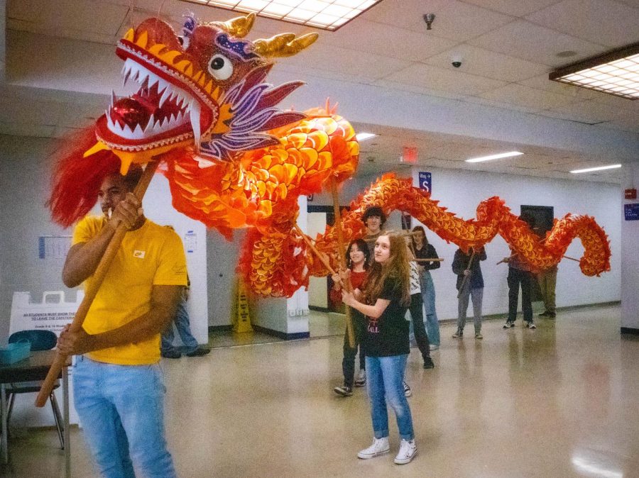 Students perform a traditional dragon dance in the cafeteria to celebrate Chinese New Year.