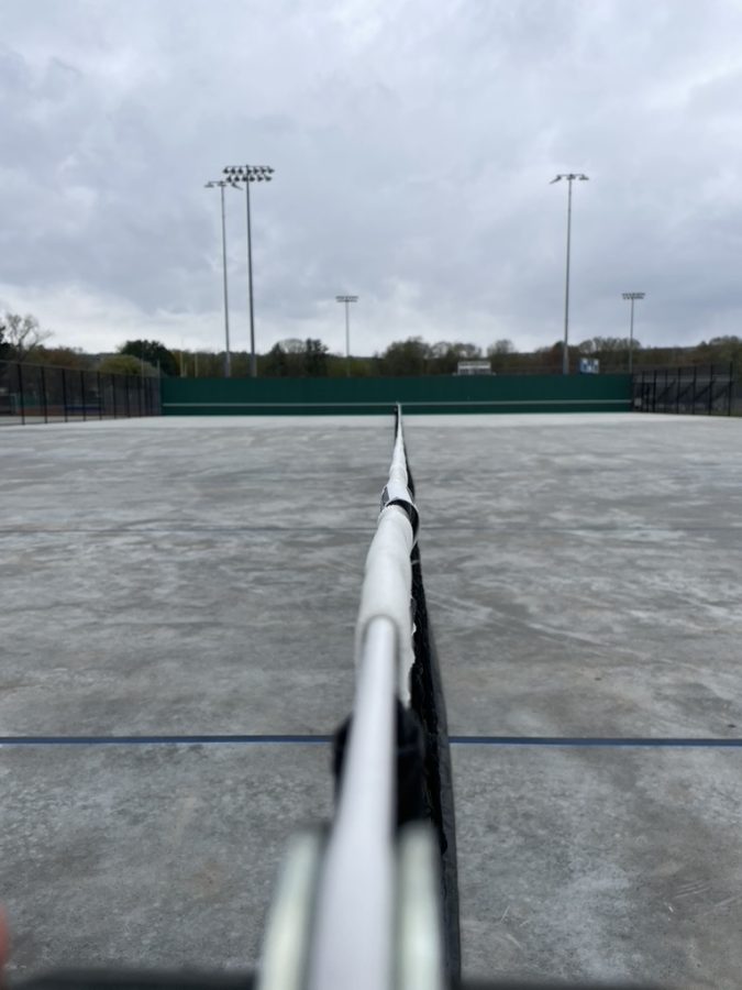 The tennis courts looking far from normal with grey concret instead of green and blue.