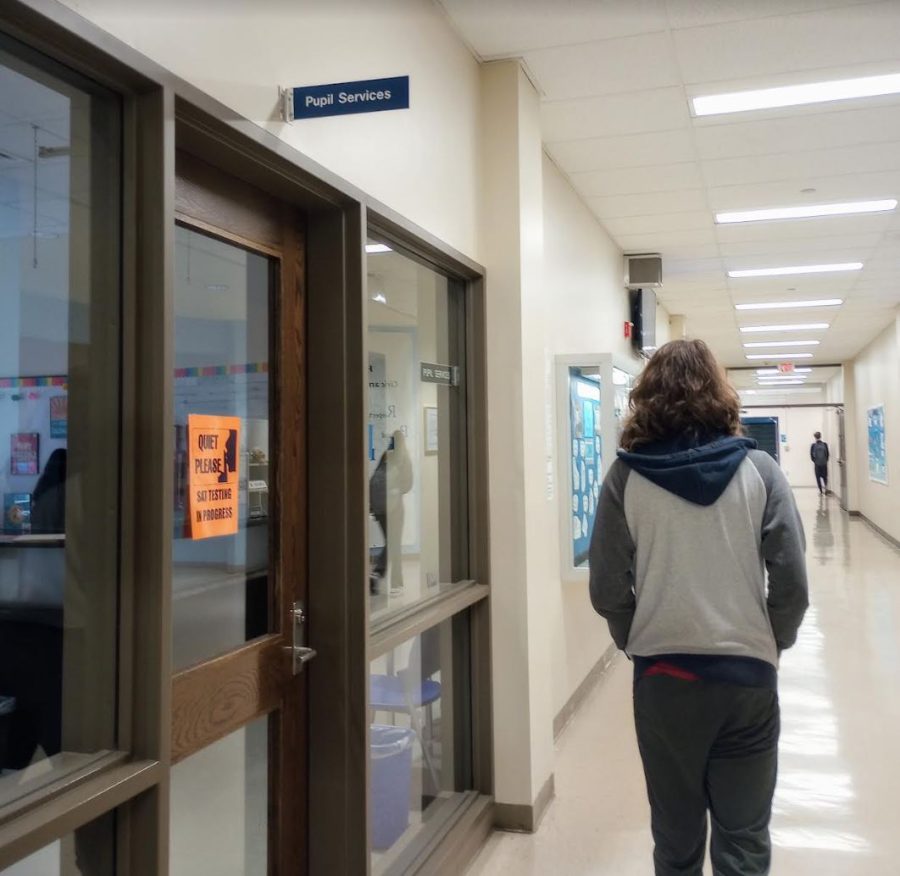 A student of Hall High School walking past Pupil Services, a place where students are able to talk to school psychiatrists.