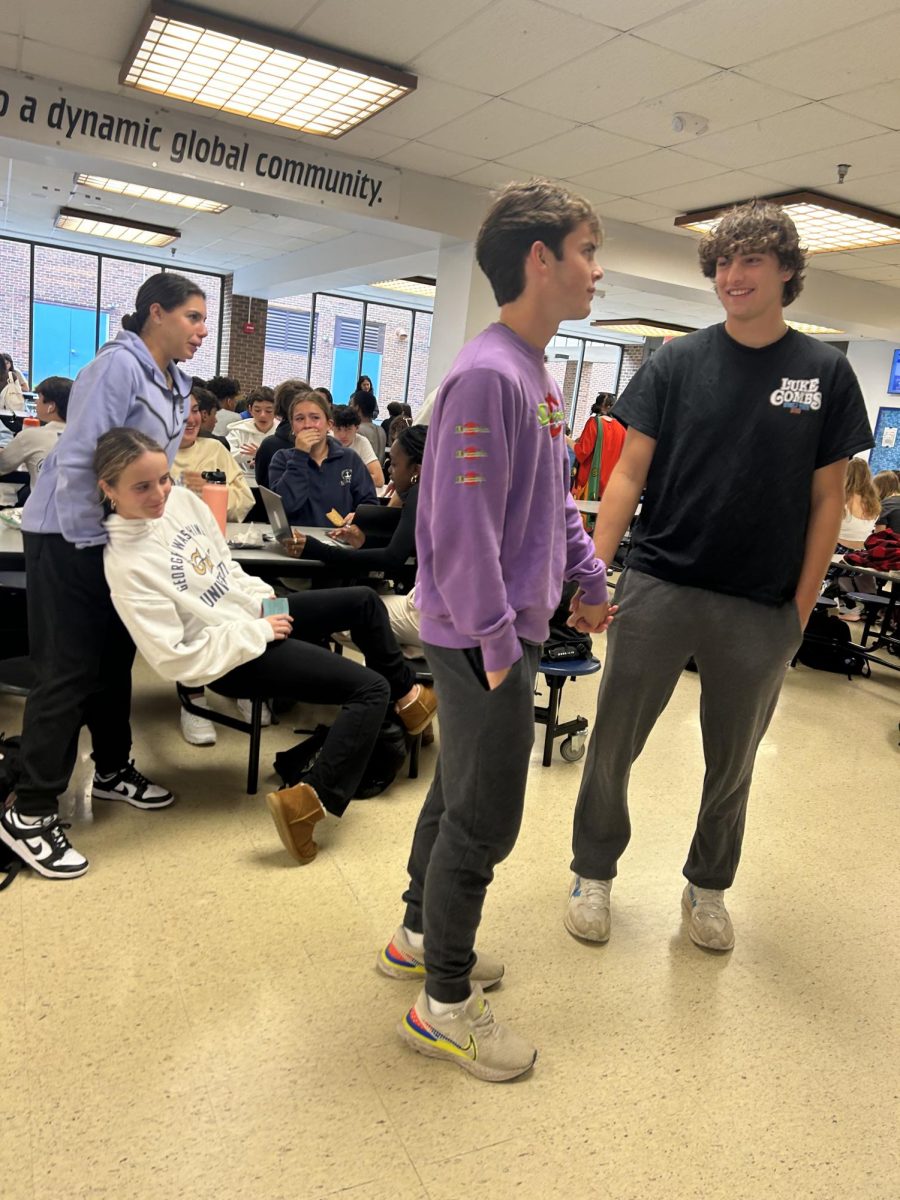 Tommy Nash  and Ben Gwizdowski  seen holding hands in the cafeteria. Students behind the interaction are taken away from their lunch conversation to watch the couple.