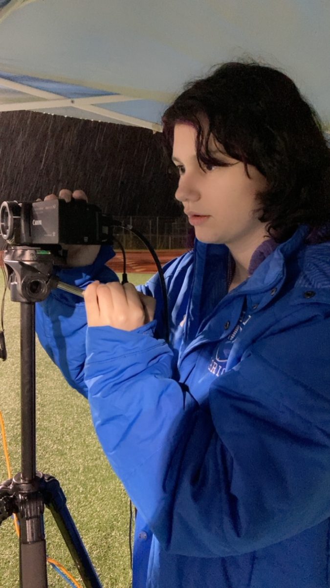 Natalie filming for the Hall football team.