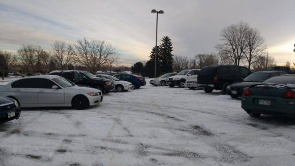 Cars in snow covered parking lot