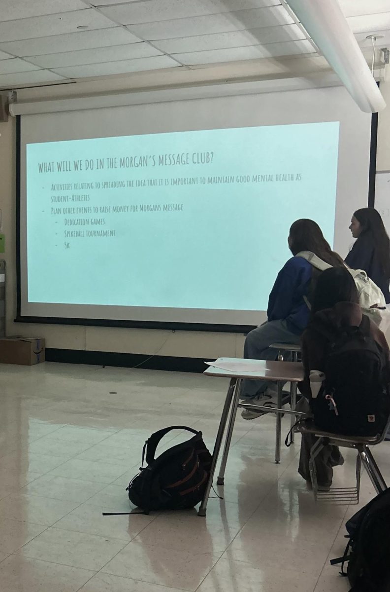 On October 15, Nory McDonald, Ella Goldberg, and other club member look at the screen describing what being a part of Morgans Message’s club involves. 