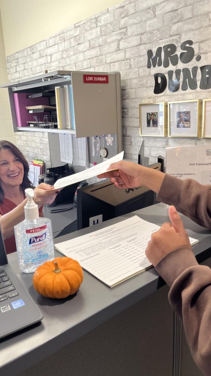 October 22 laziah handing in her transcript release form to Lori-Ann Dunbar.