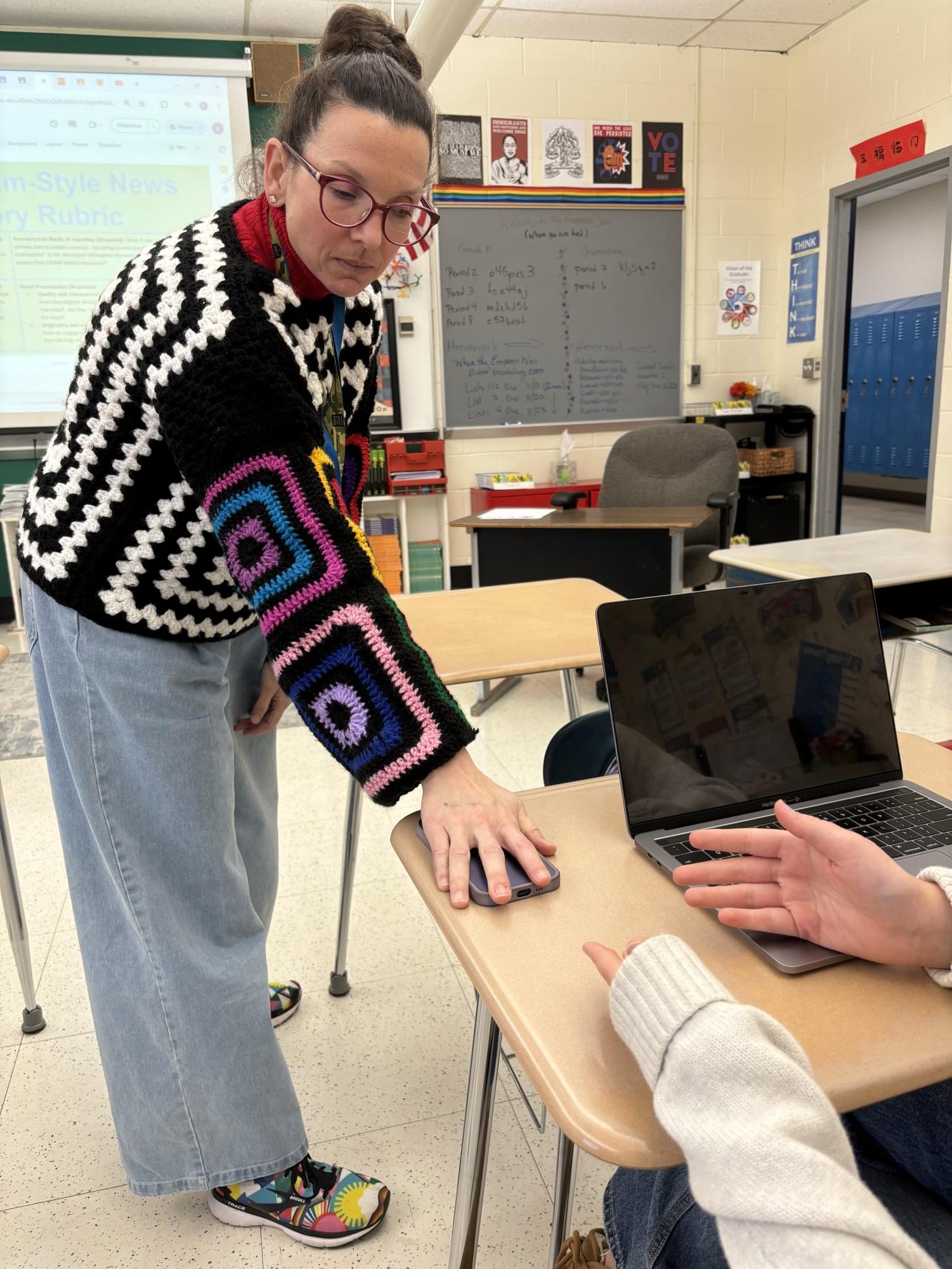 This image shows a Hall High School teacher taking a students phone.