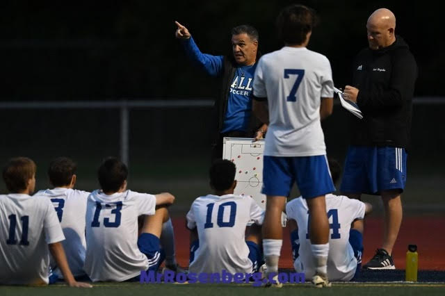 Hall Head Coach Zeke Seguro gives a half time talk to his team. 