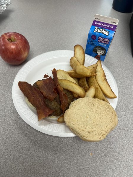 A well-balanced meal at the Hall High School cafeteria featuring a bacon burger, potato wedges, an apple, and  chocolate milk, providing a mix of protein, carbohydrates, and nutrients. March 18, 2025
