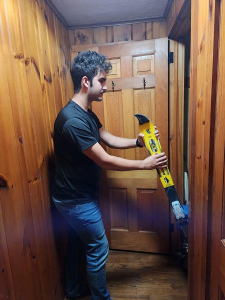 A student pulls his skis out of the winter storage closet to get ready for the ski season.