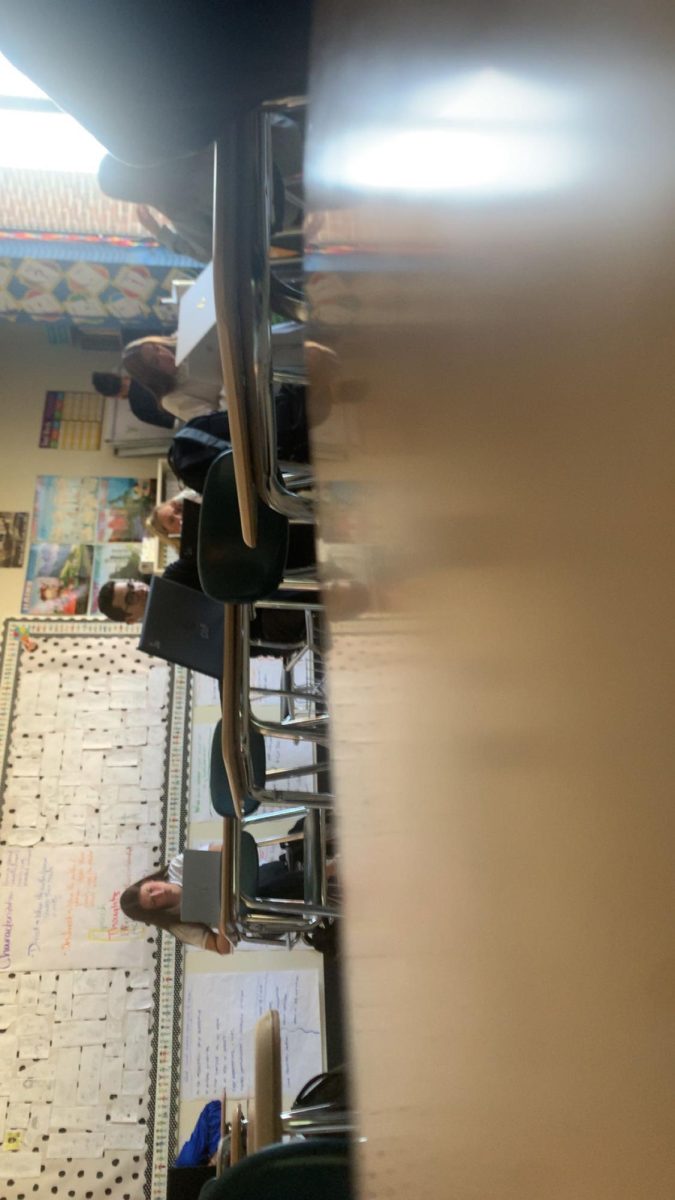 Students all in a classroom doing their work in class after the 2nd bell rang.