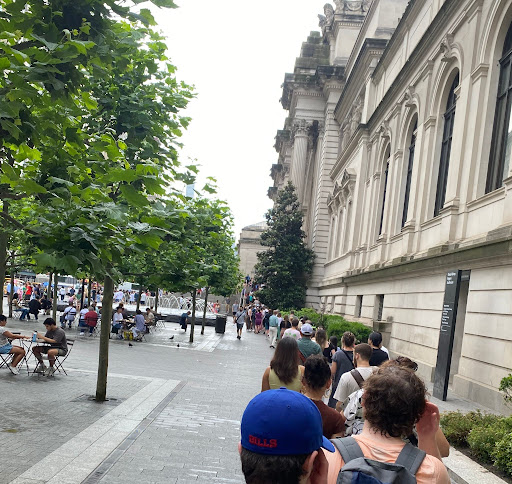 Teens line up outside for access to the Metropolitan Museum in New York City on a humid day, showing that travel is alive and well among Gen Z.