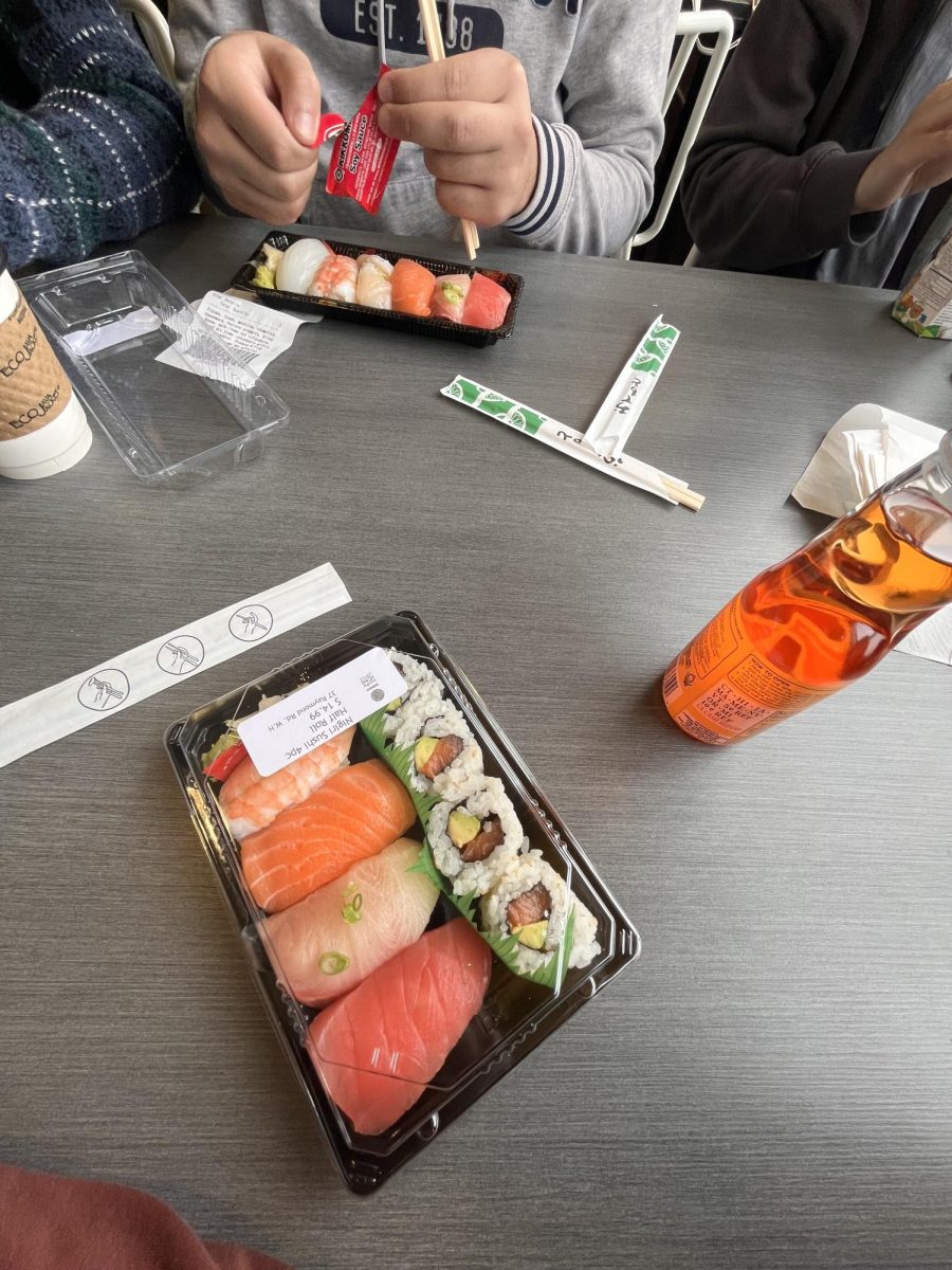 A group of teens enjoying a quick snack together. 