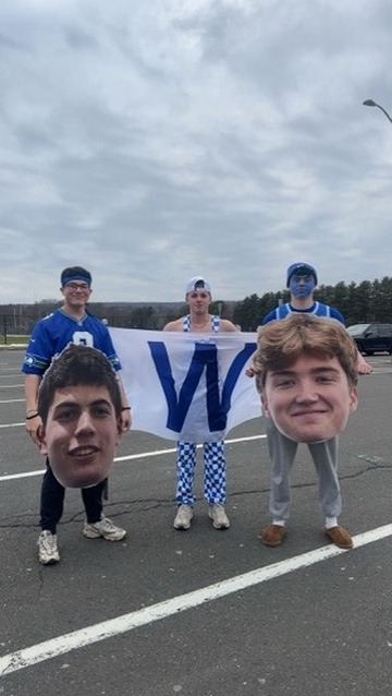 Three hall students prepare to cheer on the hockey team as they fight for a state championship at Quinnipiac. Athletics and positive cheering is a large part of our generation, and this photo represents how students show support for athletics and their community.
