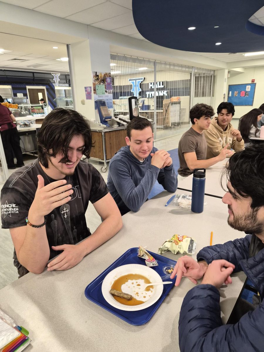 Three students discussing their lunch meals