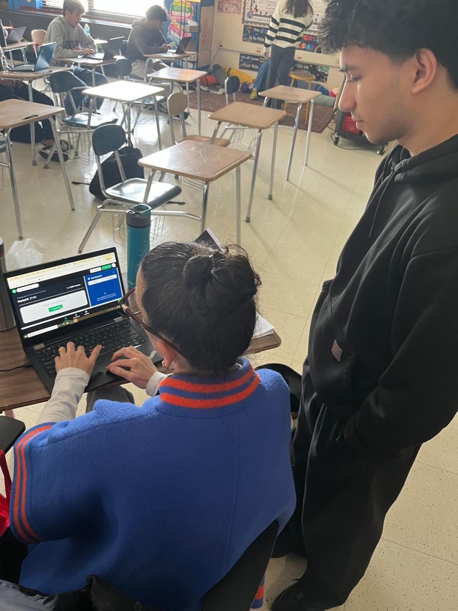This is a picture of Matheus a student from Hall High School asking to go to the bathroom and his teacher Mrs. Fransen going into smartpass and making him a pass in the system in order for him to go to the bathroom
